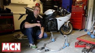 How to Use a paddock stand  Products  Motorcyclenewscom [upl. by Ylluz]